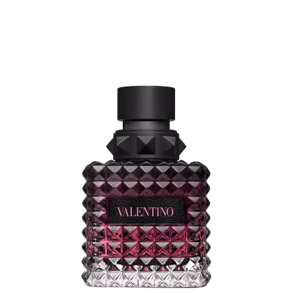 Frasco de perfume Valentino com design facetado em tons de rosa e preto, com rótulo destacado em letras pretas.