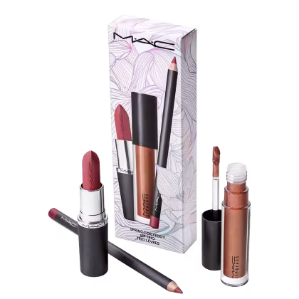 Conjunto de produtos de maquiagem da marca MAC, incluindo um batom rosa, um lápis de boca e um gloss dourado em embalagens pretas e brancas com padrões florais.