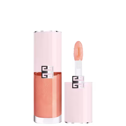 Produto de maquiagem com embalagem rosa e laranja, com logotipo Givenchy visível. Frasco cilíndrico com aplicador na ponta, contendo produto de textura cremosa em tom salmão.