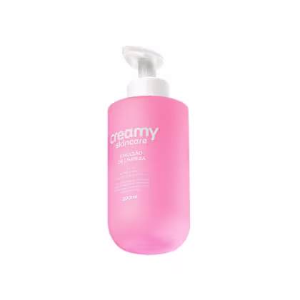 Emulsão de limpeza Creamy Skincare em frasco branco e rosa, com bomba dosadora. Rótulo com o nome da marca e informações sobre o produto.