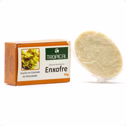 Sabonete de glicerina Enxofre da marca Tropical, em embalagem laranja e verde com imagem de flores amarelas. O sabonete possui formato oval e textura translúcida.