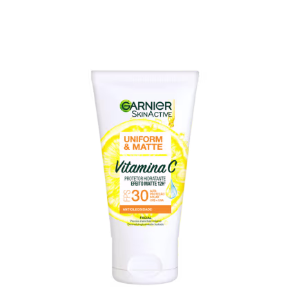 Frasco branco de protetor solar facial Garnier SkinActive com fator de proteção solar 30, contendo vitamina C, com acabamento uniforme e mate, conforme indicado no rótulo.