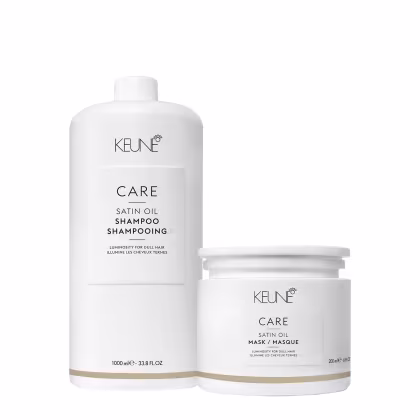 Dois produtos da linha Keune Care Satin Oil: um frasco de shampoo  de 1000 ml e um pote de máscara de 200 ml, ambos em embalagens brancas com detalhes dourados.