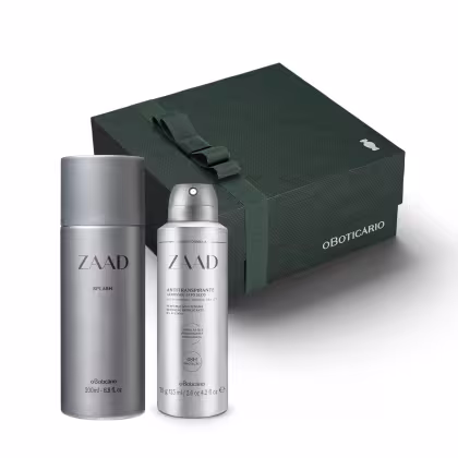 Na imagem um spray corporal de 200ml e um desodorante antitranspirante de 75g. Ambos tem formato cilíndrico e cor cinza prateado. Atrás há uma caixa presenteável na cor verde.