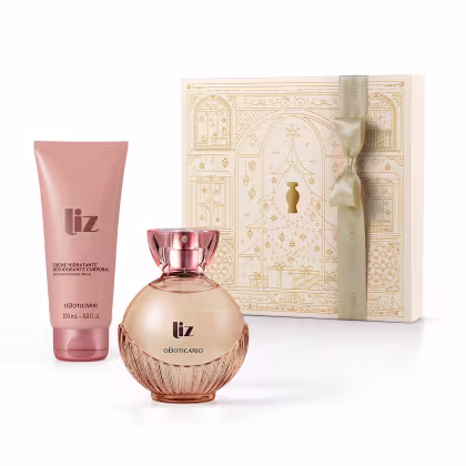 Apresenta um conjunto de desodorante colônia e creme hidratante da marca Liz: um frasco de vidro rosa dourado com detalhes texturizados e embalagem tipo bisnaga na cor rosa.. Inclui uma caixa bege com padrões geométricos dourados estampados.