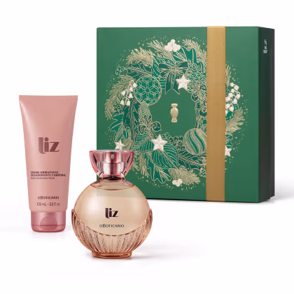 Conjunto de produtos de beleza da marca Liz, composto por um frasco de perfume em formato arredondado e uma embalagem de creme hidratante em tons de rosa e dourado, apresentados em uma caixa verde com detalhes dourados e ilustrações florais.