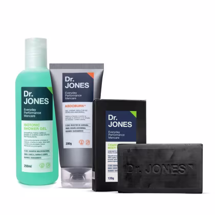 A imagem mostra produtos da marca Dr. Jones. Um shampoo em embalagem transparente com cor verde clara. Um creme abdominal em tubo cinza. Um sabonete corporal preto e a em embalagem também preta.