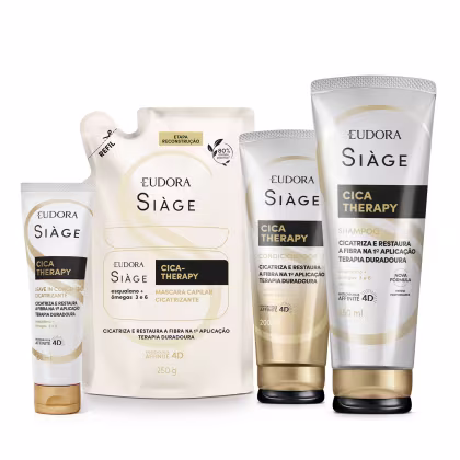 A imagem mostra um kit com quatro produtos, uma bisnaga pequena de leave-in, um refil de máscara capilar, uma bisnaga de condicionador e outra de shampoo. Todos com embalagem bege, letras pretas e douradas no rótulo.