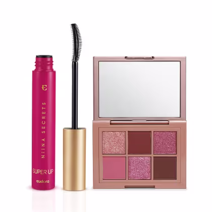 Frasco rosa de rímel Super Up da Niina Secrets, com escova preta, e paleta de sombras em tons de rosa e marrom em embalagem rosada com espelho.