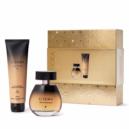 A imagem mostra produtos da linha "Eudora Velvet Sensual". Inclui um frasco de perfume em vidro âmbar com detalhes pretos, uma loção corporal em um frasco preto e uma caixa de presente dourada com padrão geométrico em relevo.