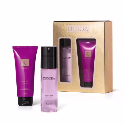 Conjunto de produtos de beleza Eudora, composto por um creme hidratante corporal, um desodorante em spray e uma caixa dourada com o logotipo da marca. As embalagens apresentam cores predominantes de roxo e dourado.