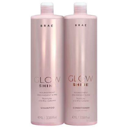 Dois frascos rosa da linha Glow Shine da marca Braé, contendo shampoo e condicionador para nutrição e brilho radiante. Os frascos possuem rótulos com o nome da linha e informações sobre os produtos.