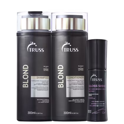 Na imagem há um frasco de shampoo e condicionador com pigmentos violetas para neutralizar os tons amarelados. Também há um frasco de um reparador de pontas. Todos os produtos têm embalagens pretas com detalhes em branco e apresentam o logotipo da Truss.