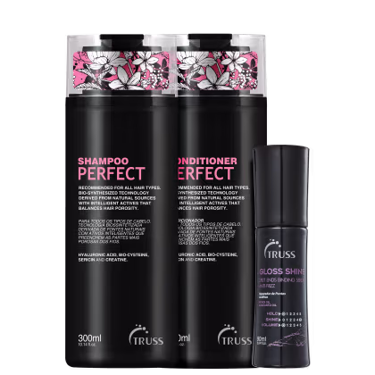 Produtos capilares da marca Truss. Dois frascos pretos de 300ml, um para shampoo e outro para condicionador Perfect, com rótulos em rosa e branco com estampas florais. Há também um frasco menor de um produto para brilho dos cabelos chamado "Gloss Shine".