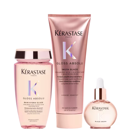 Três produtos da marca Kérastase: um frasco rosa de shampoo Gloss Absolu, um tubo rosa de condicionador Insta Glaze e um frasco de vidro com conta-gotas Glaze Drops, todos com design e rótulos da marca.
