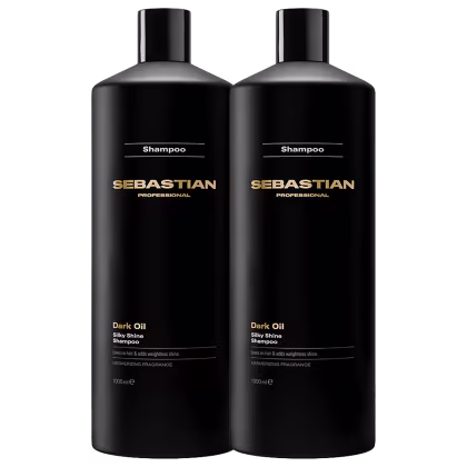 Dois frascos pretos de shampoo da marca Sebastian Professional, com rótulos dourados indicando a linha "Dark Oil Silky Shine". Os frascos possuem design elegante e moderno, com formato cilíndrico e tampa preta.