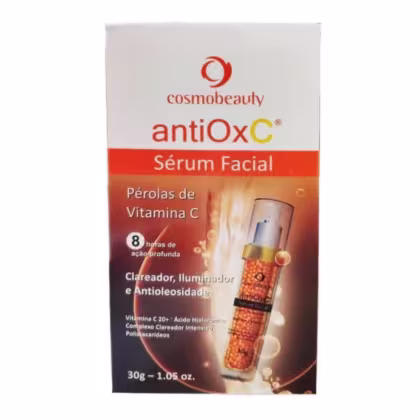 Caixa branca com logotipo Cosmobeauty e nome do produto "antiOxC Sérum Facial" em destaque. Contém informações sobre os ingredientes, como "Pérolas de Vitamina C" e "Ácido Hialurônico". Embalagem com 30g