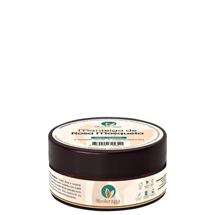 O produto apresentado é um pote de manteiga de rosa mosqueta da marca Oleoterapia Brasil. O pote é de cor marrom escuro, com um rótulo verde e branco que exibe o nome da marca e do produto.