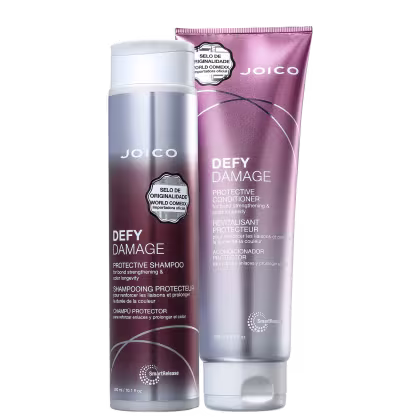 A imagem mostra dois produtos da linha "Defy Damage" da marca Joico: shampoo e condicionador. As embalagens são roxas com tons prateados e letras brancas.