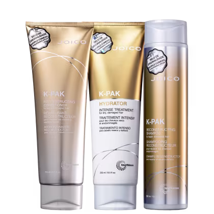 A imagem apresenta shampoo, condicionador e máscara da linha K-Pak da Joico, com embalagens plásticas com tom dourado e branco.