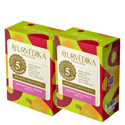 duas caixas de sabonete sólido da marca Ayurvedika. O texto indica que se trata de um sabonete vegetal com ingredientes ayurvédicos, como bergamota, hibisco e lótus. Cada caixa contém 120g do produto.