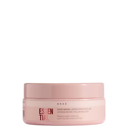 Máscara capilar em embalagem plástica rosa claro. A embalagem tem formato cilíndrico com tampa removível.