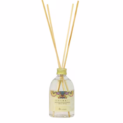 Difusor de aromas Serena da Kailash, em frasco de vidro transparente com rótulo decorativo, contendo líquido incolor e hastes de madeira para dispersão do aroma.