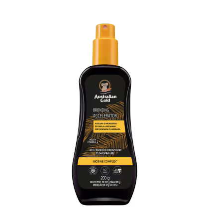 Bronzeador Spray Gel com rótulo amarelo e texto "Australian Gold Bronzing Accelerator". O frasco contém um produto de bronzeamento em spray com fórmula Biosine Complex, indicado para acelerar o bronzeado.