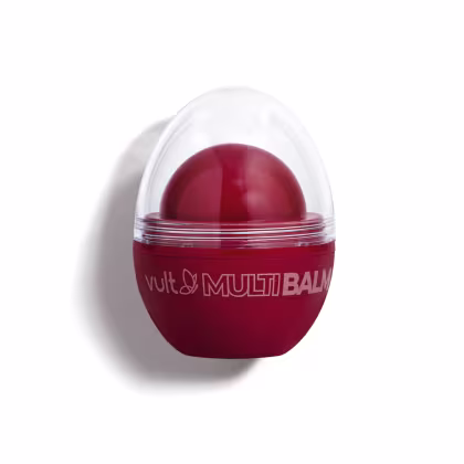 Produto de beleza Vult em embalagem vermelha com cúpula transparente, contendo um bálsamo de cor vermelha em seu interior. O rótulo exibe o nome "Vult Multi Balm" em destaque.