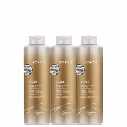 Três frascos de shampoo reconstrutor Joico K-Pak, com embalagem em tons dourados e brancos, exibindo o nome da marca e a descrição do produto.