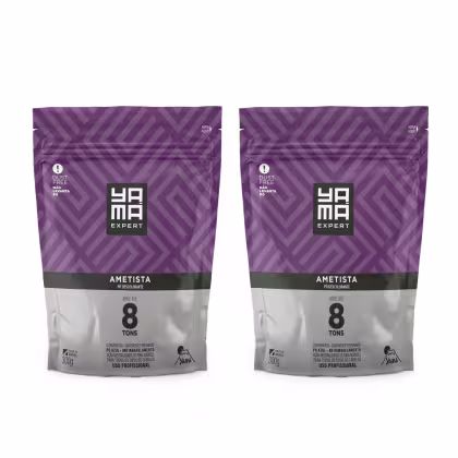 Dois pacotes de pó descolorante Yamá Expert Ametista, em embalagens plásticas com design geométrico roxo e branco, contendo 300g cada, com informações sobre o produto impressas.