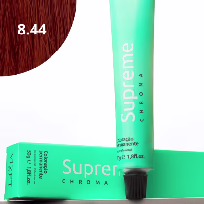 A imagem mostra a embalagem em tubo plástico verde claro com o nome da marca e produto impresso. Caixa retangular verde com detalhes do produto, incluindo a cor e o volume de 50g. No canto superior há uma pequena mecha com o tom da coloração.