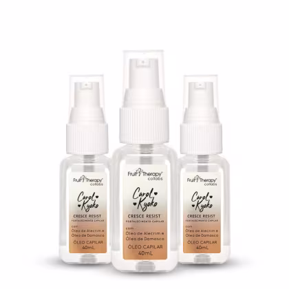 A imagem mostra 3 frascos de 40ml do óleo capilar transparente, permitindo ver o líquido dentro, e possui um pulverizador branco na parte superior. O produto é indicado para o fortalecimento dos fios.