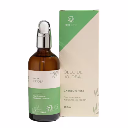 Óleo de jojoba em frasco âmbar de 100ml com tampa cromada. Embalagem retangular verde e bege com o logotipo Eco Care. Rótulos indicam que é um óleo para cabelo e pele. Destaca-se como um produto natural e vegano da linha Eco Care Biocosméticos.