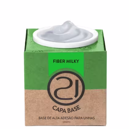 A imagem mostra uma base de alta adesão para unhas. O produto vem em uma embalagem retangular de papelão verde e marrom. No centro, há um recipiente branco contendo o produto, que parece ser um gel branco.