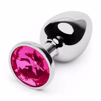 O produto apresentado é um plug anal de metal com uma grande gema rosa brilhante na extremidade. O corpo do plug é prateado e polido, com uma forma arredondada e suave.