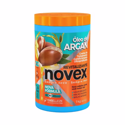 A imagem mostra o Creme de Tratamento Óleo de Argan 1kg da marca Novex. É um pote plástico cilíndrico na cor azul com tampa laranja. O rótulo destaca que o produto oferece restauração, brilho e nutrição profunda.