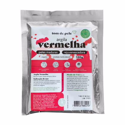 Argila vermelha da marca Tom de Pele. A embalagem contém 100g do produto. O rótulo indica que a argilavermelha é um produto 100% natural, vegano, sem crueldade animal, rejuvenescedor e indicado para peles maduras.