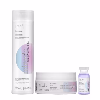 Shampoo, máscara e booster da linha Emáh Hair Care, com embalagens brancas e detalhes em cores pastel. O shampoo possui 250 mL, a máscara 200 g e o booster 13 mL, todos com sistema de ácido hialurônico.