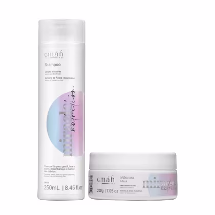 O conjunto de produtos Emáh Hair Care inclui um frasco de shampoo branco com rótulo rosa e azul, e um pote de máscara branco com rótulo semelhante. Ambos os produtos apresentam o sistema de ácido hialurônico como destaque em seus rótulos.
