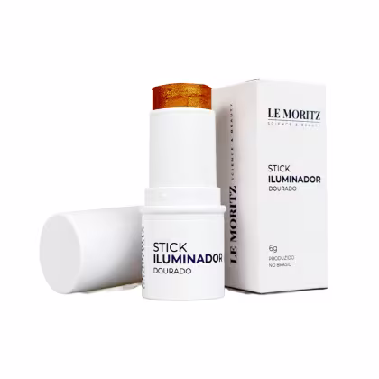 Stick iluminador dourado da marca Le Moritz, em embalagem branca com rótulo destacado. Produto de 6g, produzido no Brasil, com design minimalista e acabamento metálico na parte superior.