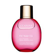 É uma embalagem redonda de vidro rosa vívido com um líquido vermelho brilhante dentro. A tampa é dourada metálica. No frente da embalagem, está escrito "Fix' Make-Up" e "Fixa o Maquillage Hidrata, Refresca, Acalma" em letras brancas.