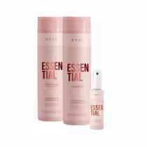 Conjunto de produtos Braé Essential, composto por shampoo, condicionador e leave-in spray, em embalagens rosa claro com detalhes em vermelho, exibindo o nome "Essential" em destaque.
