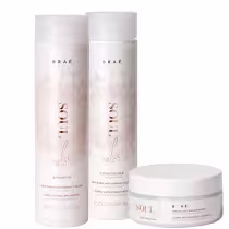 Conjunto de produtos Braé, incluindo shampoo, condicionador e máscara para cabelos, em embalagens brancas com detalhes em dourado, exibindo o nome da marca e informações sobre os benefícios dos produtos.