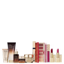 A imagem mostra uma variedade de produtos de beleza da marca Estée Lauder. Há frascos e embalagens de cosméticos e skincare, incluindo cremes, séruns, paleta de sombras, batons, gloss labial, delineador labial e máscara de cílios.