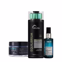 Produtos da marca Truss, incluindo um frasco de shampoo de 300ml, um pote de máscara capilar e um frasco de óleo reconstrutor, todos em embalagens pretas e verdes com detalhes em dourado.