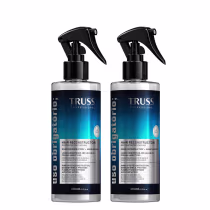 Dois frascos de 260ml do Reconstructor Capilar da linha Truss Professional, com embalagem preta e azul, apresentando rótulo com informações sobre o produto e seu uso.