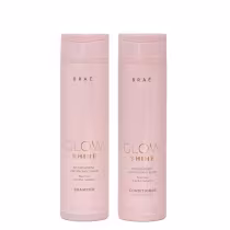 Dois frascos de plástico rosa claro contendo shampoo e condicionador da linha Glow Shine da marca Braé. Os frascos cilíndricos têm 250 ml e apresentam rótulos com o nome da marca e da linha em letras brancas.