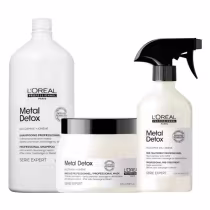 A imagem mostra um kit com três produtos da marca L'Oréal Professionnel. Um frasco grande e branco de 1,5L de shampoo, um pote redondo de máscara branco com tampa preta e um frasco branco com borrifador preto.