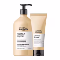 A imagem mostra um kit da linha Absolut Repair da L'Oréal Professionnel, com um frasco de shampoo com pump preto e uma bisnaga de condicionador com tampa preta. Todos de cor bege com rótulo branco.
